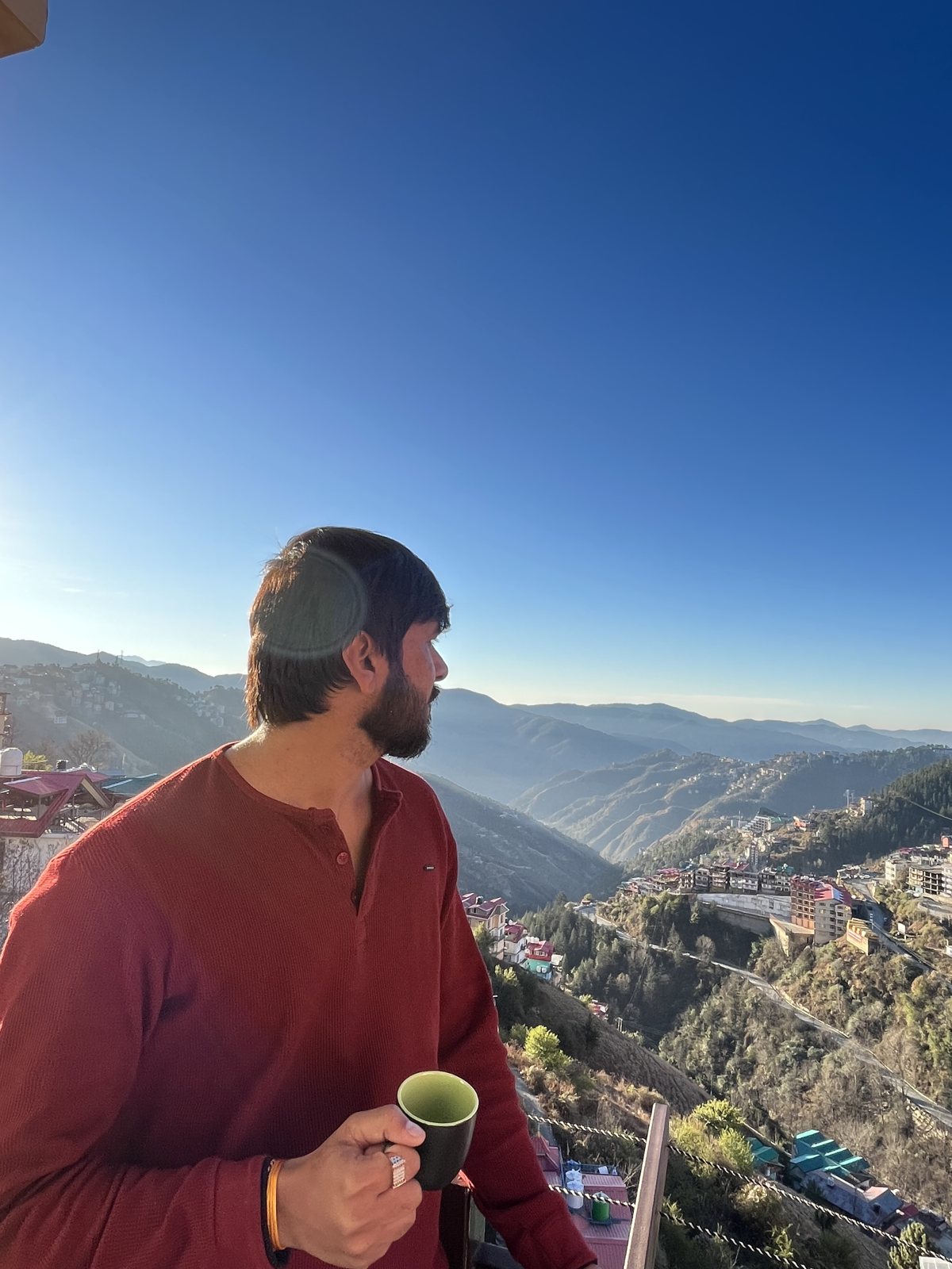 Pratik with morning chai overlooking a Himalayan hill town
