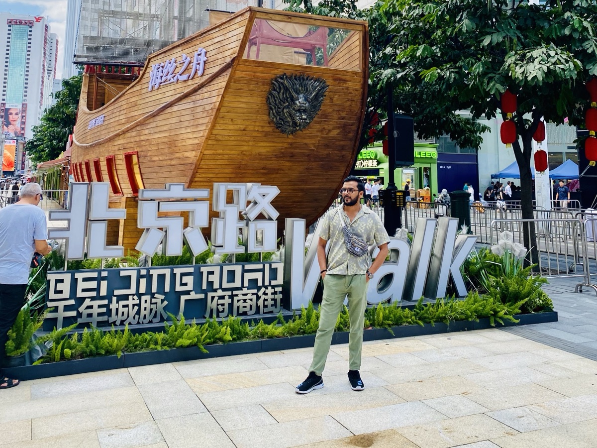 Pratik standing before a giant wooden ship sculpture on Beijing Road, Guangzhou, China